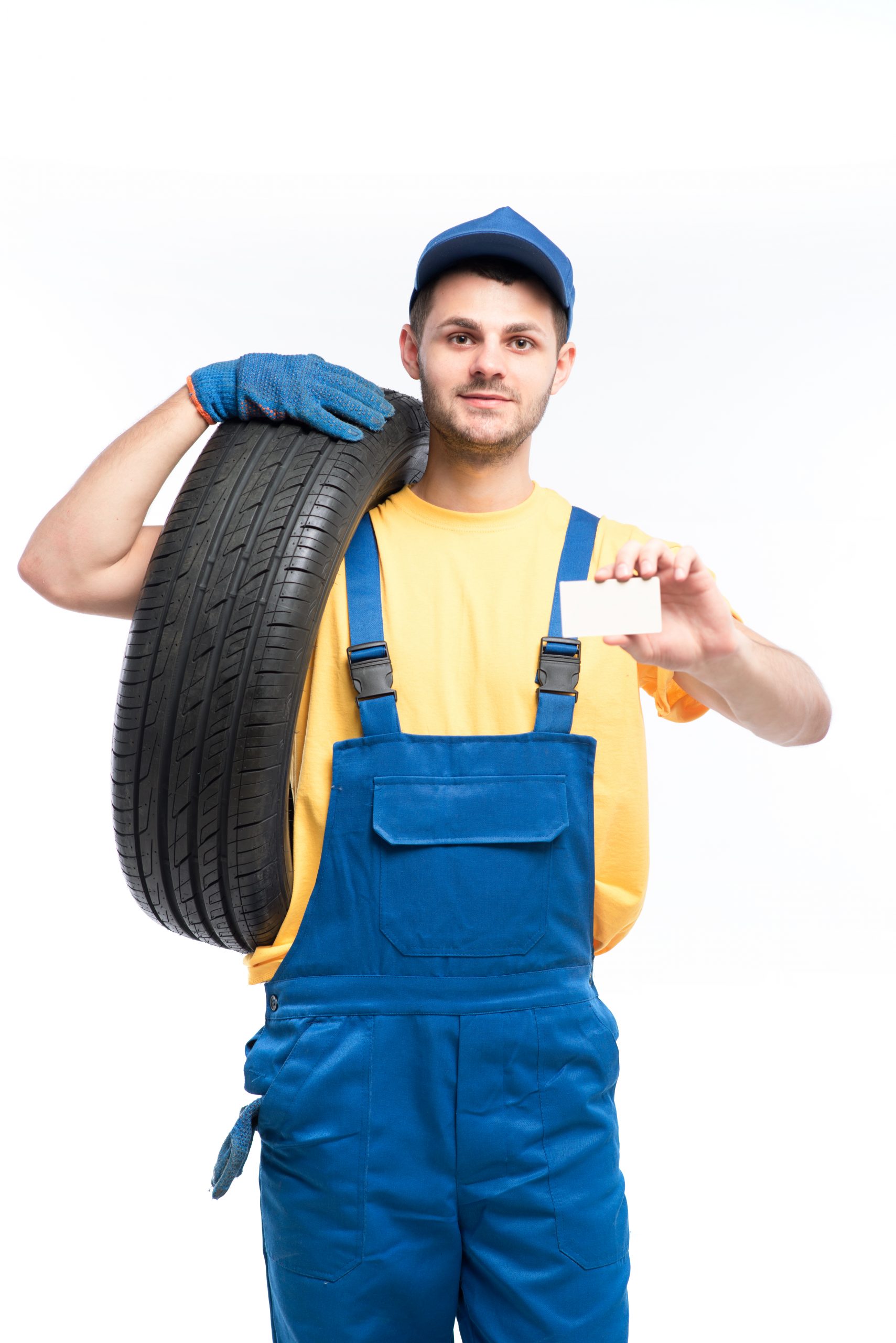 Worker holds tire and empty businesscard in hands